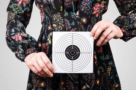 Woman with paper target in hands. Health, menopause, hygiene and well-being conceptの写真素材
