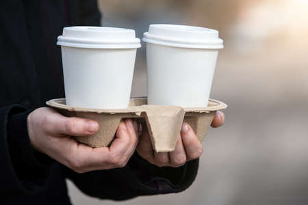 Paper coffee cups to take away. Early morning, breakfast and start of the working day