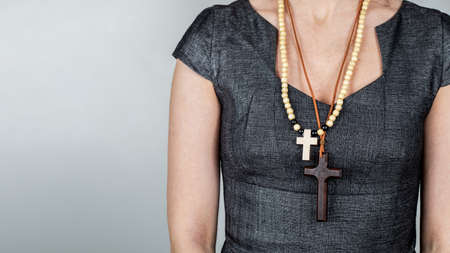 Woman with wooden crosses around her neck. Religion and beliefの写真素材