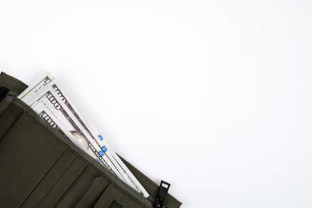 Green wallet with dollar banknotes on a white background. Copy spaceの写真素材