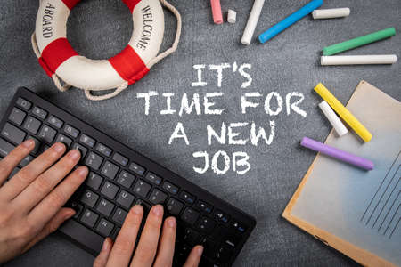 Its Time for a New Job. Computer keyboard on a black dropped whiteboard background