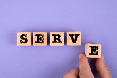 SERVE. Wooden cubes with text on a purple background