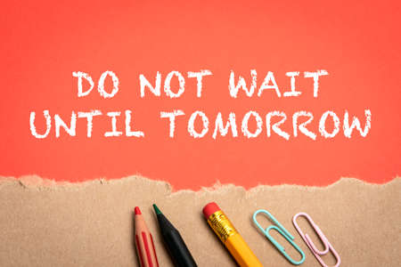 Do Not Wait Until Tomorrow. Office supplies and torn cardboard