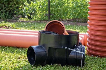 Orange plastic sewer pipes. Reconstruction and installation