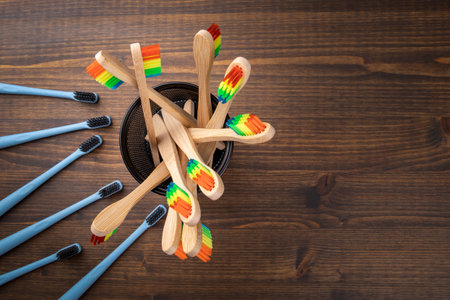 Environmentally friendly and plastic toothbrushes on a wooden background. health and hygieneの写真素材