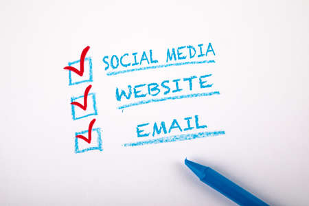Digital Marketing concept. Social Media, Website and Email. Checklist on a sheet of white paper