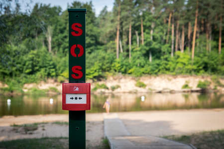 SOS alarm button on the beach to call rescuers
