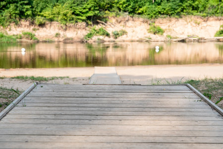 Pier on the beach. Wooden footbridge and footpath to the beach and riverの写真素材