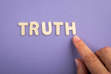 Truth. White letters and a mans hand on a purple backgroundの写真素材