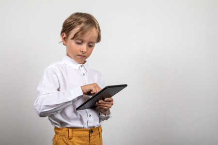 Tablet in boys hands. Learning and entertainmentの写真素材