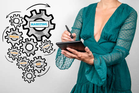 MARKETING Business concept. Woman in a green dress with tablet computer