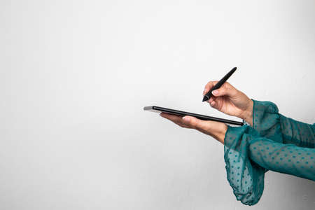 Tablet in woman hands. Free space for advertising and text