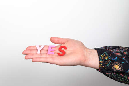 YES, word from colored letters on a womans palm