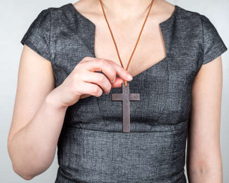 Woman with a wooden cross around her neckの写真素材