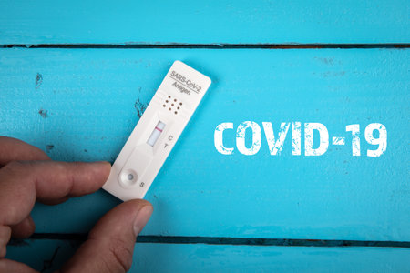 Covid-19. On a blue wooden table negative Covid test