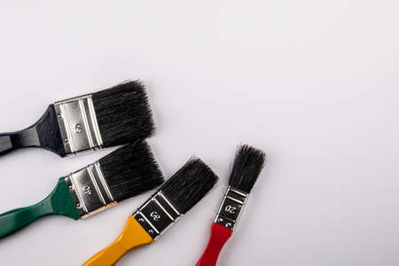Colored Paint Brushes of different sizes. Copy space for text, illustration and advertisingの写真素材