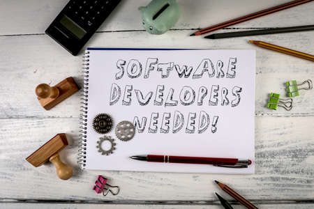 Software Developers Needed. Job Offer Concept. Office Desk