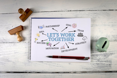 Lets work together. Notebook on a white wooden office deskの写真素材