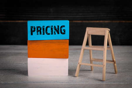 Pricing, Business concept. Colored wooden blocks in a pile and stairsの写真素材