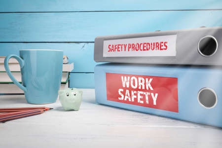 Work Safety and Safety Procedures concept. Wooden table and office suppliesの写真素材