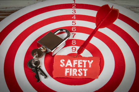 Safety First. Note pinned with a dart in the middle of the targetの写真素材