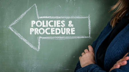 Policies and Procedure concept. Business woman, background of green chalk boardの写真素材