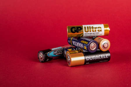 Duracell, Varta, Energizer, GP Ultra AA alkaline batteries on red backgroundのeditorial素材