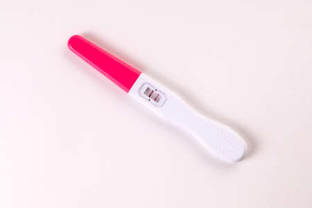 Positive pregnancy test on a white background