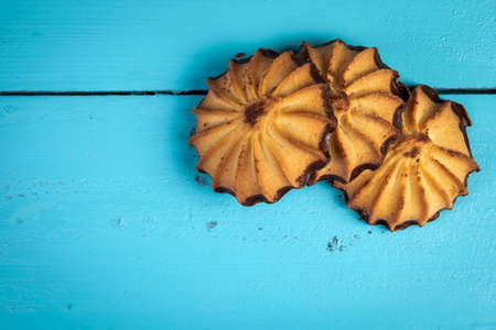 Cookies with chocolate icing on a blue wooden table
