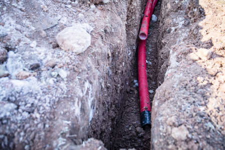 Electrical communications. Excavated trench, earthworks and constructionの写真素材
