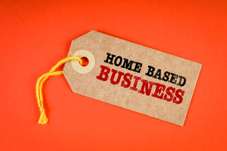 HOME BASED BUSINESS. Cardboard price tag on an orange backgroundの写真素材