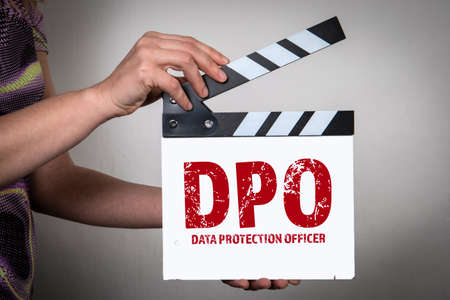 DPO Data Protection Officer Concept. Female hands holding movie clapper