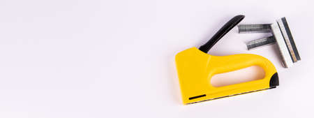 Staple gun and staples on a white background. Copy spaceの写真素材