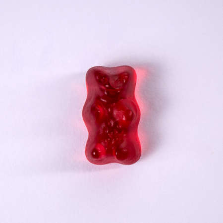 Red rubber bear on a white backgroundの写真素材