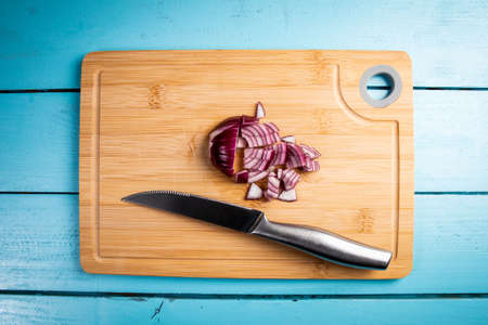 Cut purple onion on a bamboo cutting boardの写真素材
