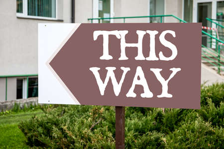 This Way. Road sign, directions arrow in the urban environmentの写真素材