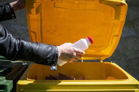 Waste sorting for recycling. Plastic bottle in yellow container