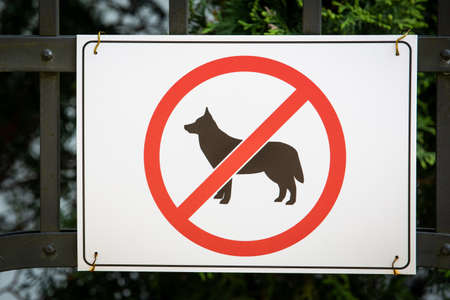 Dogs are not allowed to sign on a fence