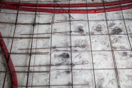 Water pipes, reinforcing mesh and foam insulation. Construction site and renovationの写真素材