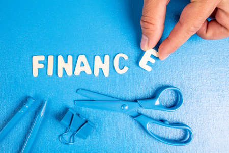 Finance. Text from white wooden letters on a blue backgroundの写真素材
