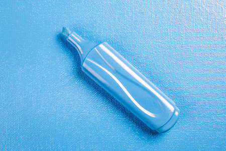 Blue marker on a blue textured background