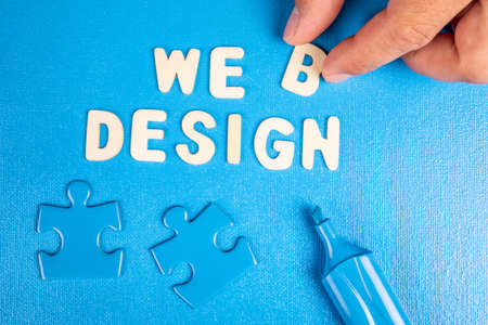 Web Design. Text from white wooden letters on a blue backgroundの写真素材