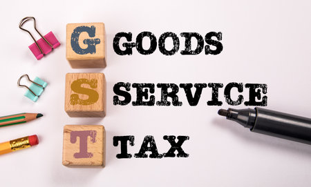 GST - Goods and Service Tax. Stationery on a white backgroundの写真素材