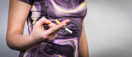 Broken cigarette in a womans hand. Quit smoking, commitment and a healthy lifestyleの写真素材