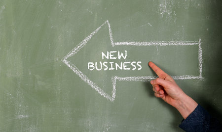 New Business. Arrow with text on green chalk board