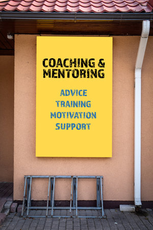Coaching and Mentoring. Yellow advertising banner with textの写真素材