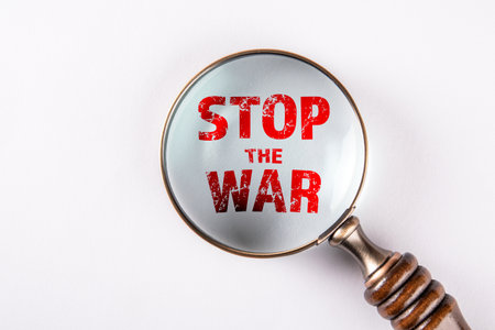 Stop the war. Magnifying glass on a white background