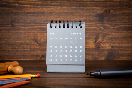 2022 December. Desk calendar on a wooden background