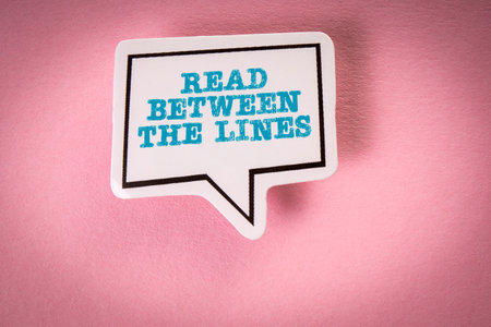 Read Between The Lines. Speech bubble with text on pink backgroundの写真素材