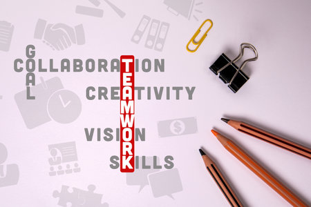 TEAMWORK concept. Illustration with text and icons, crossword puzzle. Stationery on the tableの写真素材